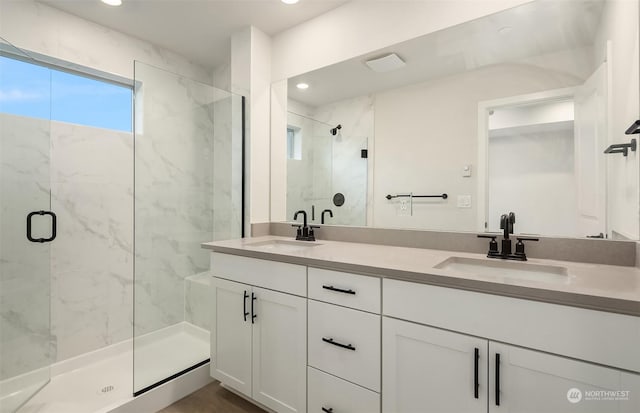 bathroom featuring an enclosed shower and vanity