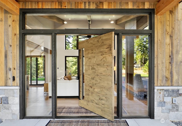 doorway featuring wooden walls