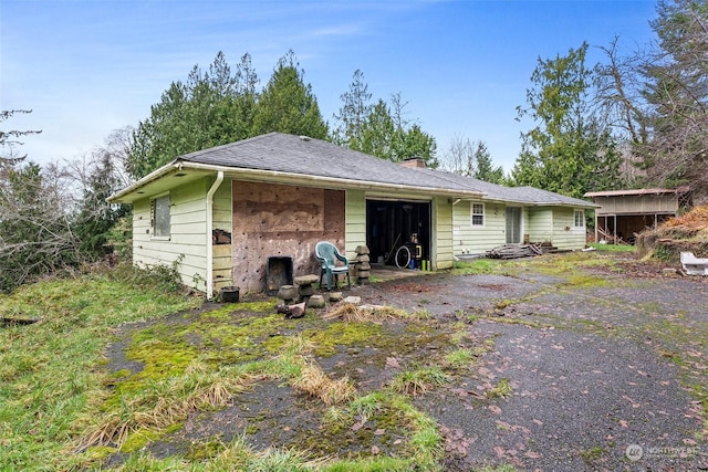 rear view of property with a garage