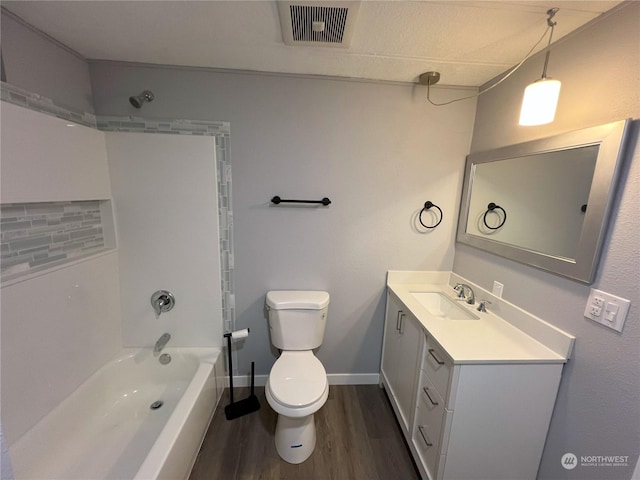 full bathroom featuring hardwood / wood-style flooring, vanity, toilet, and shower / washtub combination