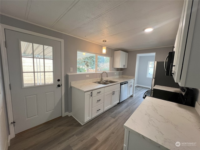 kitchen featuring white cabinets, sink, hanging light fixtures, and dishwasher