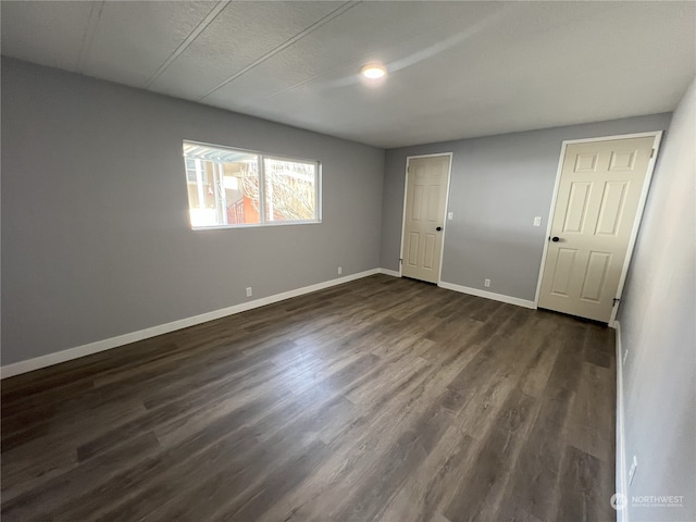 empty room with dark hardwood / wood-style floors