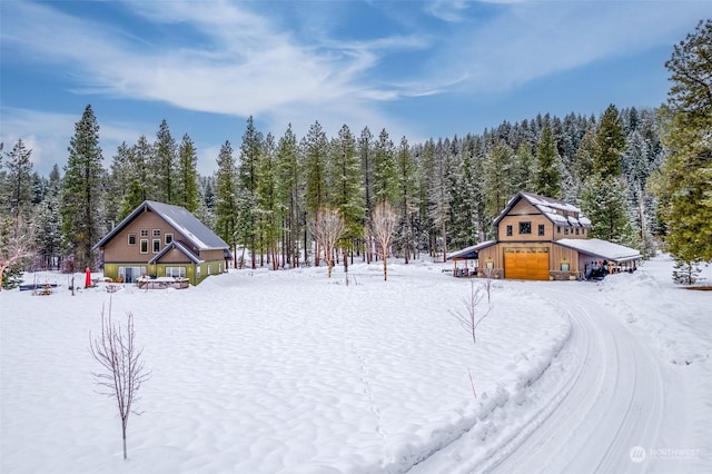 yard layered in snow with a garage