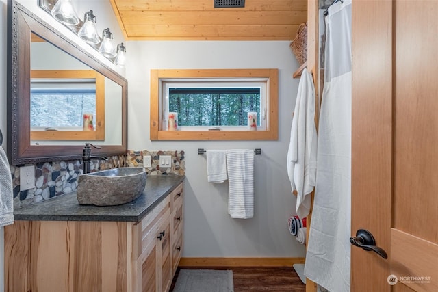 bathroom with hardwood / wood-style flooring, vanity, and wood ceiling