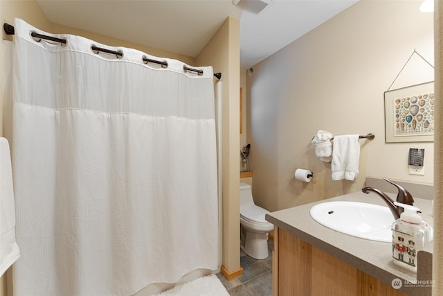 bathroom with tile patterned floors, vanity, and toilet