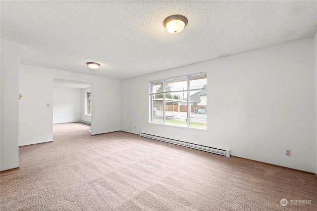 empty room featuring a textured ceiling, light carpet, and a baseboard radiator