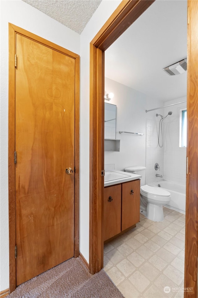 bathroom featuring visible vents, toilet, a textured ceiling, shower / bath combination, and vanity