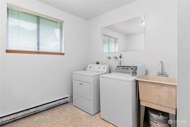 clothes washing area featuring light tile patterned floors, laundry area, a sink, independent washer and dryer, and baseboard heating