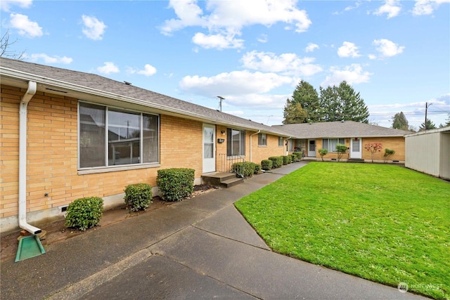 single story home with a front yard, brick siding, roof with shingles, and crawl space