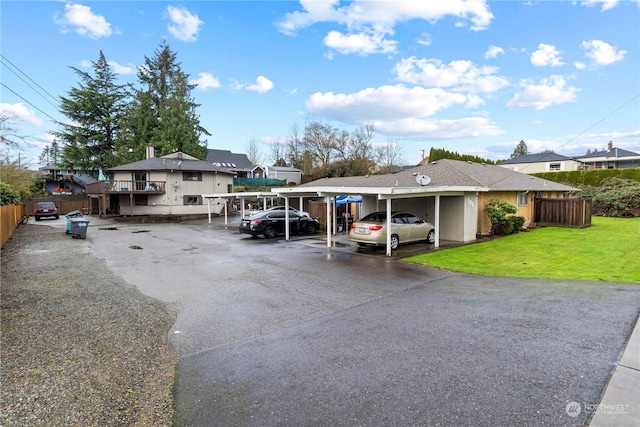 view of vehicle parking featuring a carport and a yard