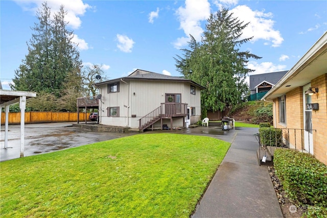 view of property exterior featuring a yard, a patio area, and fence