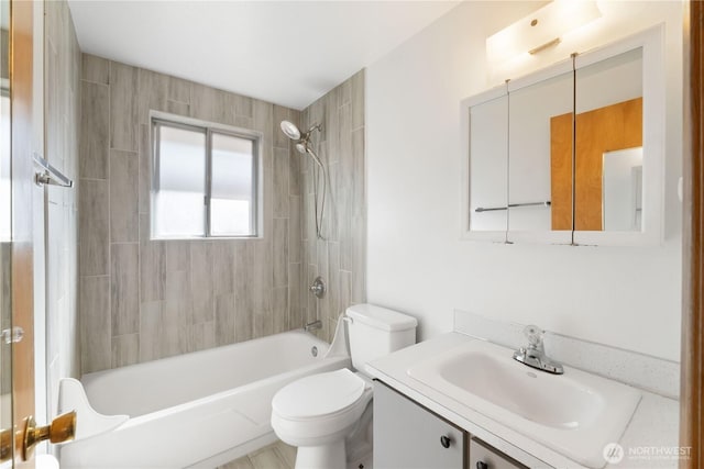 bathroom featuring toilet, vanity, and bathtub / shower combination