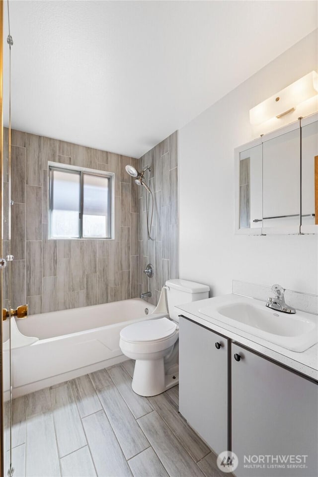 bathroom with vanity, toilet, and shower / bath combination