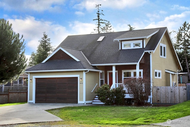 view of front of property with a front yard and a garage