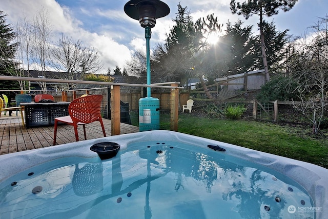 view of swimming pool with a hot tub