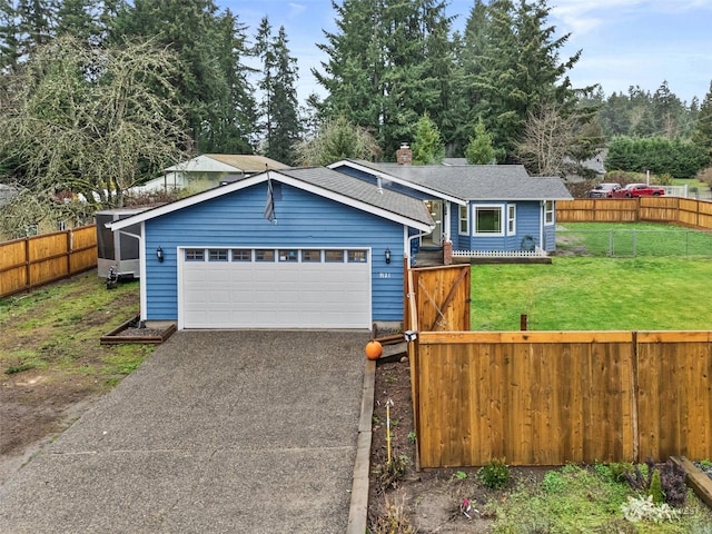 view of front of home with a front yard and a garage