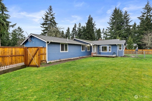 rear view of property featuring a yard