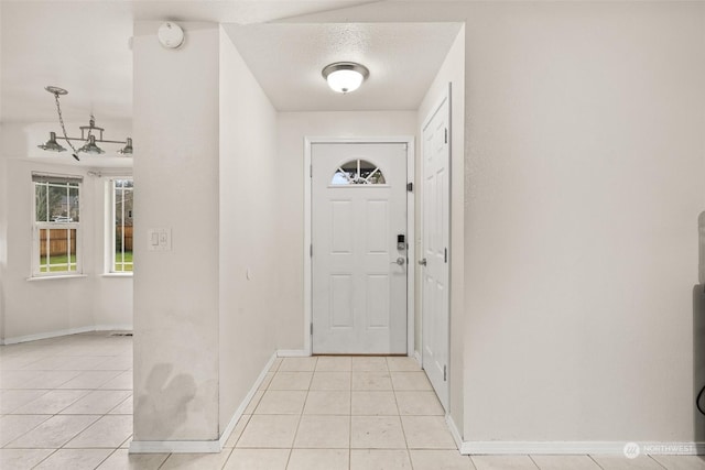 tiled foyer with a textured ceiling