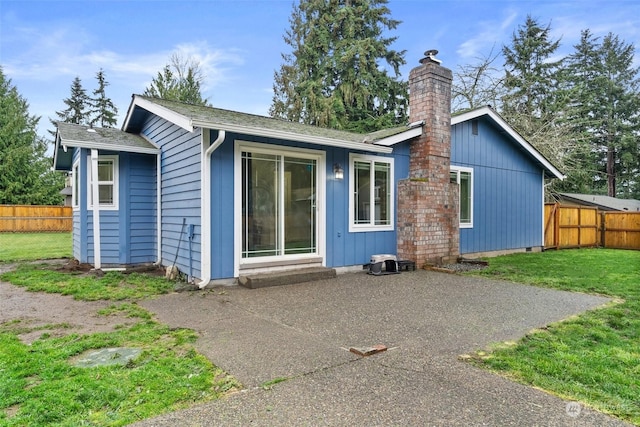 rear view of property featuring a yard