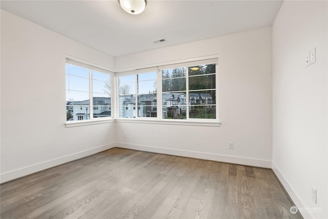 spare room featuring hardwood / wood-style floors