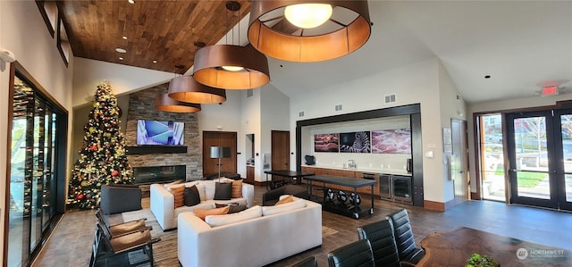 living room with high vaulted ceiling, beverage cooler, and a stone fireplace