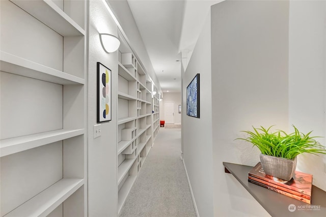 corridor featuring light colored carpet