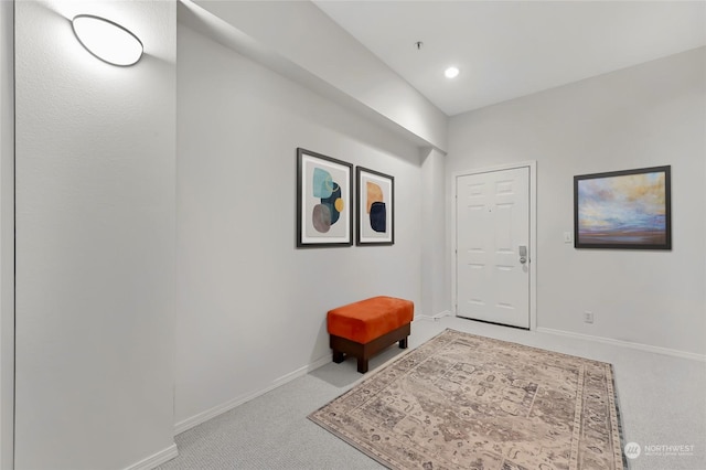 entrance foyer featuring light colored carpet