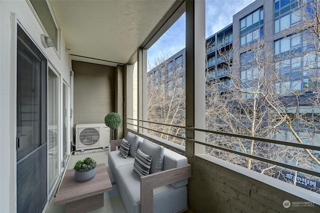 balcony featuring ac unit and outdoor lounge area