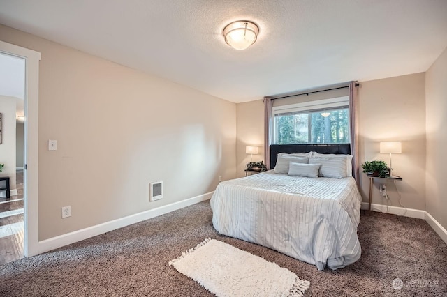 carpeted bedroom with a textured ceiling