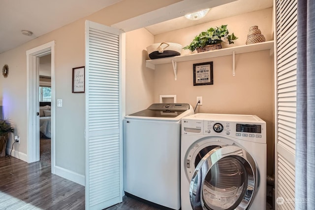 washroom featuring dark wood-type flooring and independent washer and dryer