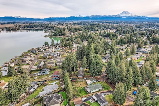 drone / aerial view featuring a water and mountain view