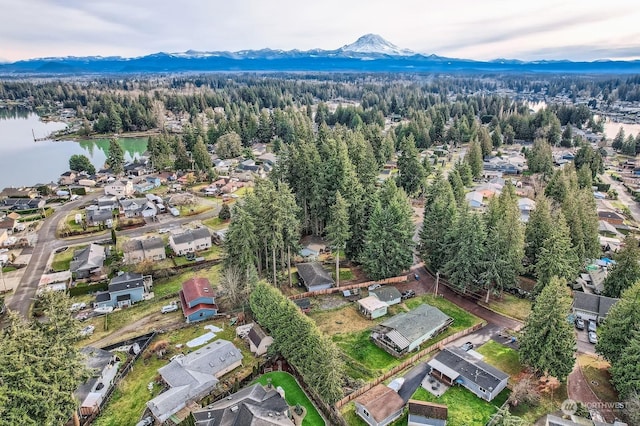 drone / aerial view featuring a water and mountain view