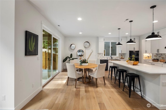 dining space featuring light hardwood / wood-style floors and sink