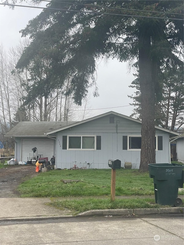 view of front of house with a front yard and a garage