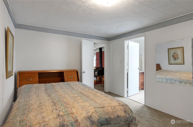 bedroom featuring ornamental molding and light carpet