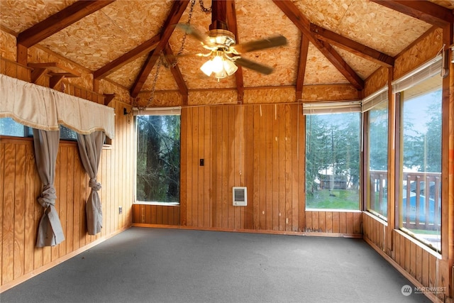 unfurnished sunroom featuring lofted ceiling with beams, heating unit, and ceiling fan