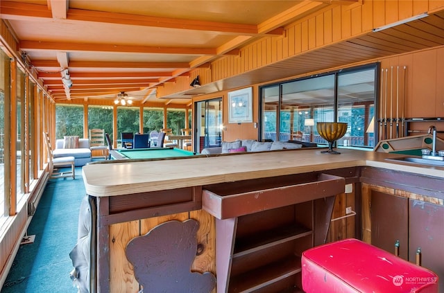 interior space featuring sink and beam ceiling