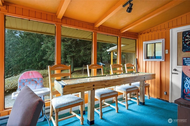 sunroom with lofted ceiling with beams