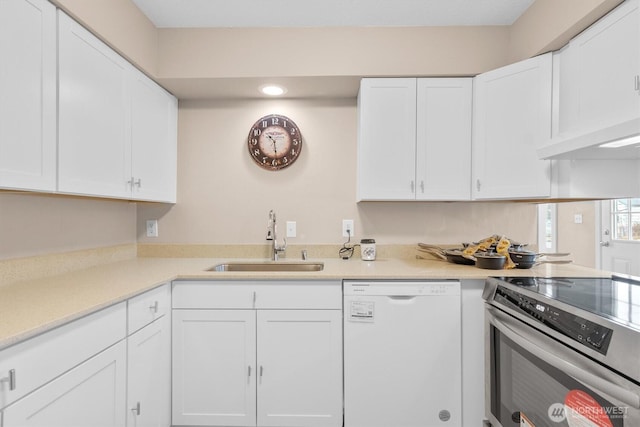 kitchen featuring electric stove, light countertops, white cabinetry, white dishwasher, and a sink