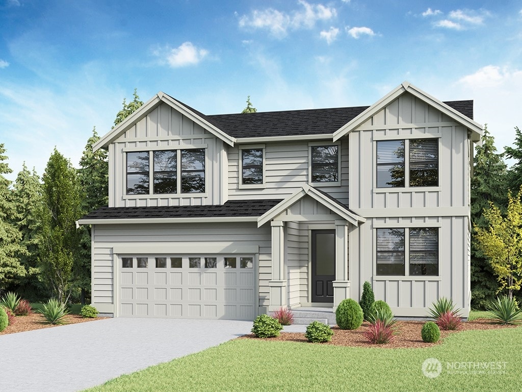 view of front of home featuring a garage and a front lawn