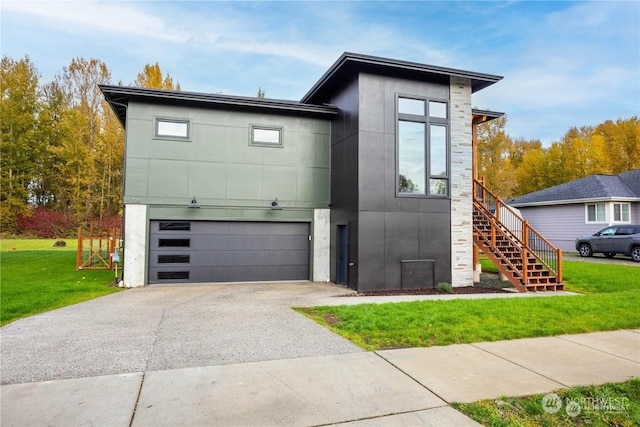 contemporary home with a front yard and a garage