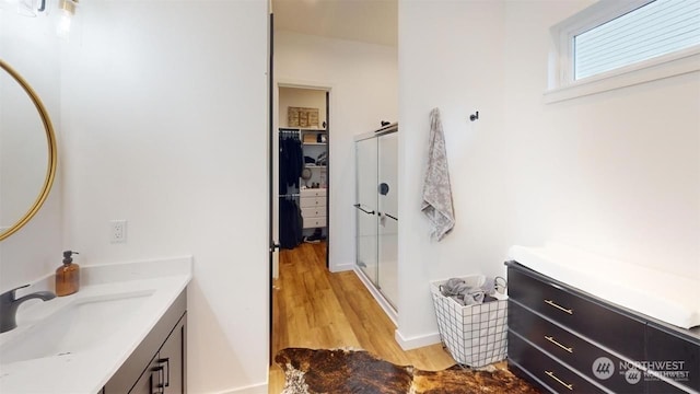 bathroom featuring vanity, hardwood / wood-style flooring, and walk in shower