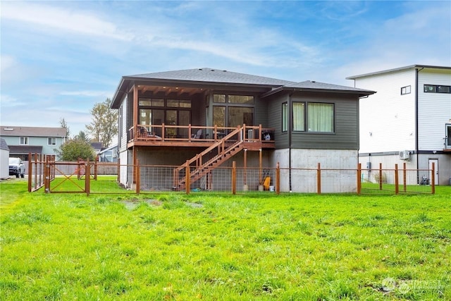 rear view of property with a sunroom, a deck, and a lawn