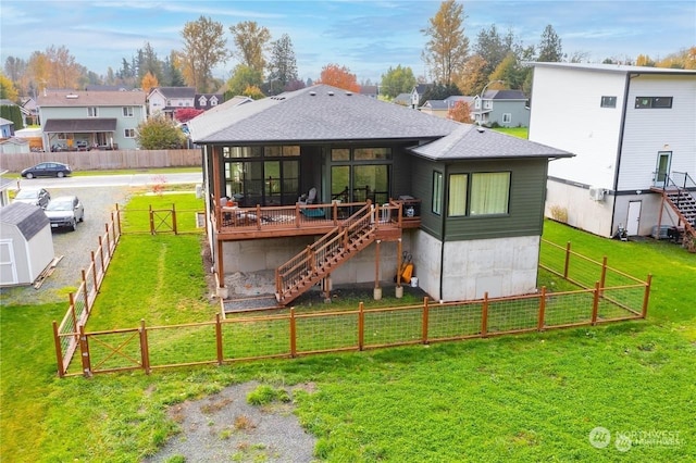 rear view of house with a yard and a deck