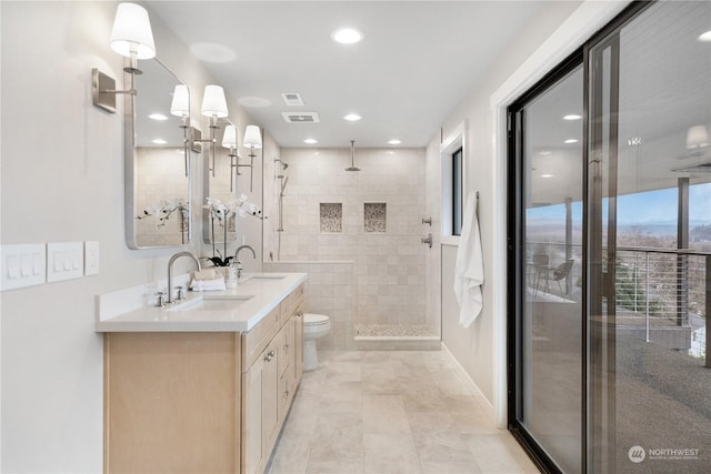 bathroom featuring vanity, toilet, and an enclosed shower