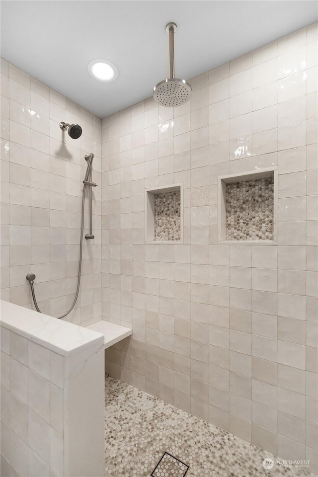 bathroom with a tile shower