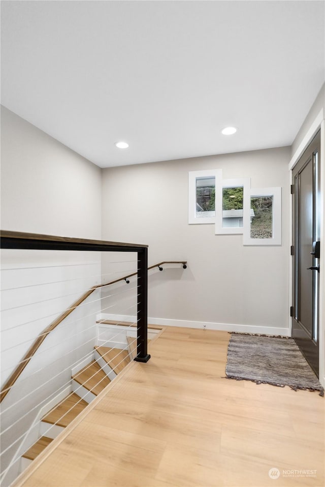 stairway featuring wood-type flooring