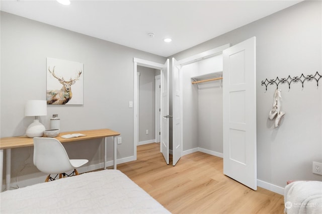 bedroom with hardwood / wood-style flooring and a closet