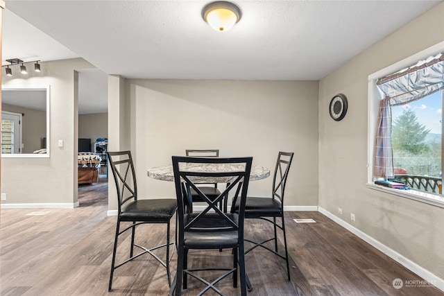 dining area with hardwood / wood-style flooring