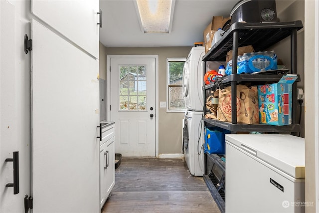 laundry area with dark hardwood / wood-style flooring and stacked washer / dryer